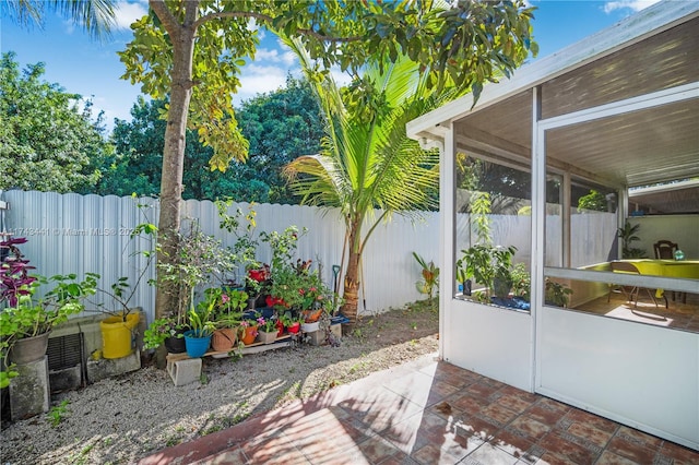 view of patio featuring a sunroom