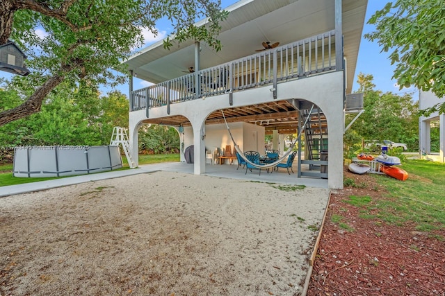 exterior space featuring ceiling fan and a patio area