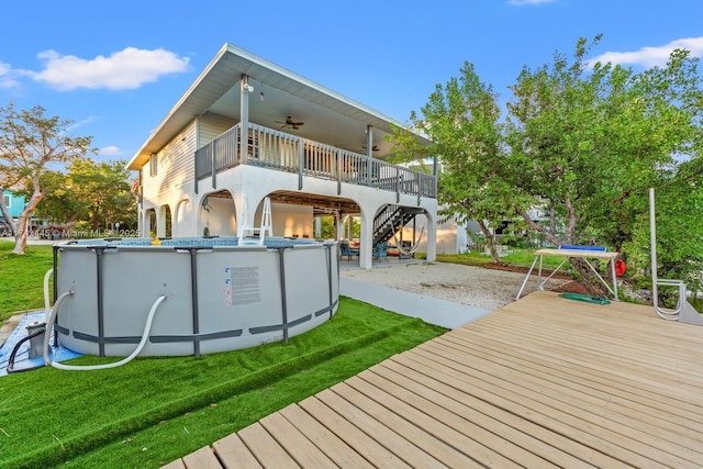 back of house featuring a yard and ceiling fan