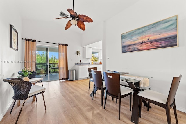 dining space featuring ceiling fan and light wood-type flooring