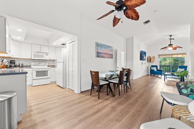 kitchen featuring white cabinetry, white appliances, light hardwood / wood-style flooring, and vaulted ceiling