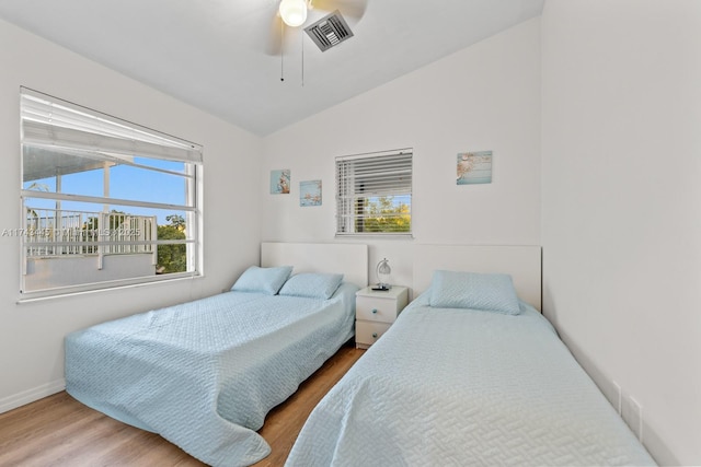 bedroom featuring vaulted ceiling, wood-type flooring, and ceiling fan