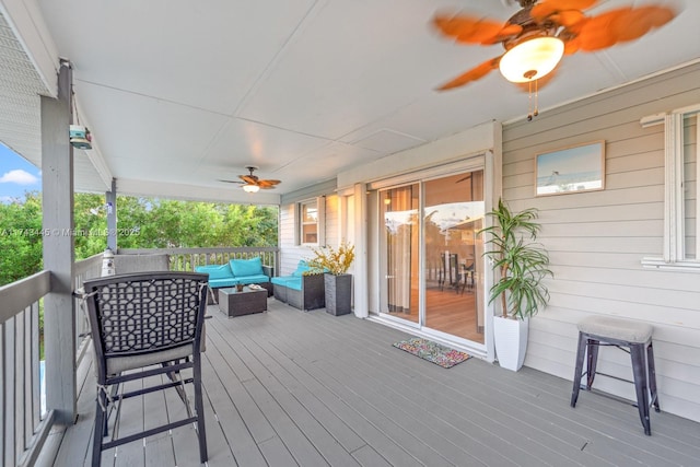 deck featuring an outdoor living space and ceiling fan