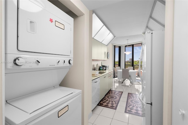 20281 E Country Club Dr Unit 403, Aventura, FL 33180 - laundry room featuring stacked washer / drying machine and light tile patterned flooring