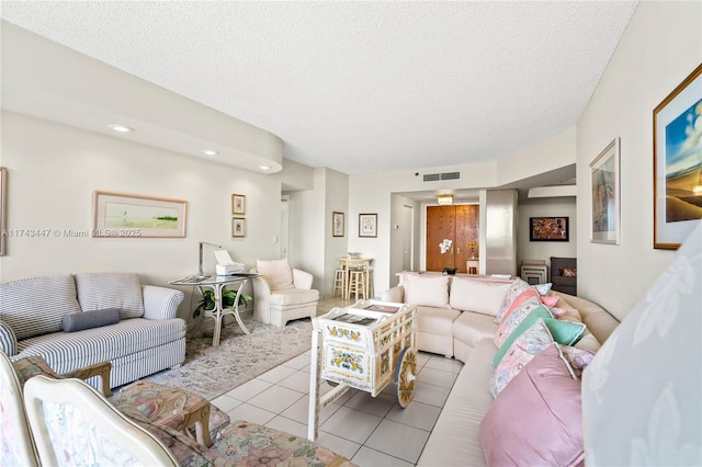 living room with light tile patterned floors and a textured ceiling