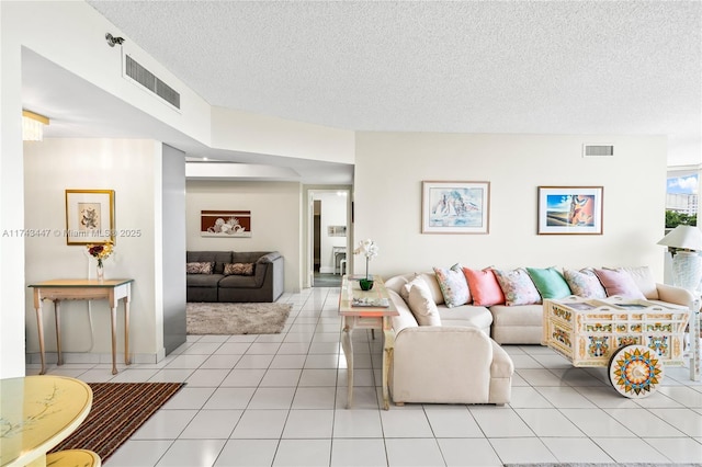 tiled living room featuring a textured ceiling