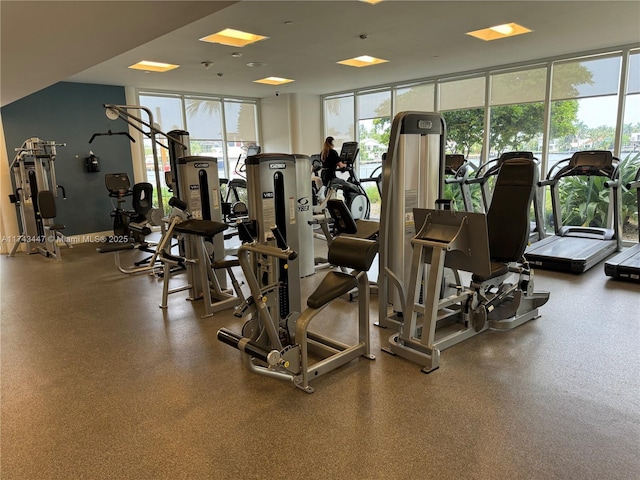 exercise room with floor to ceiling windows and plenty of natural light