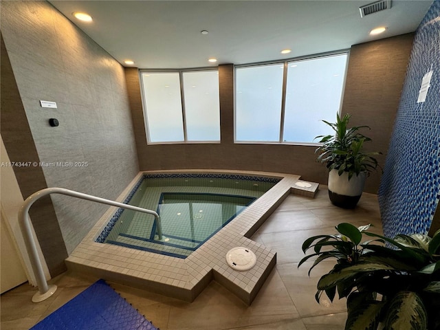 view of swimming pool featuring an indoor hot tub