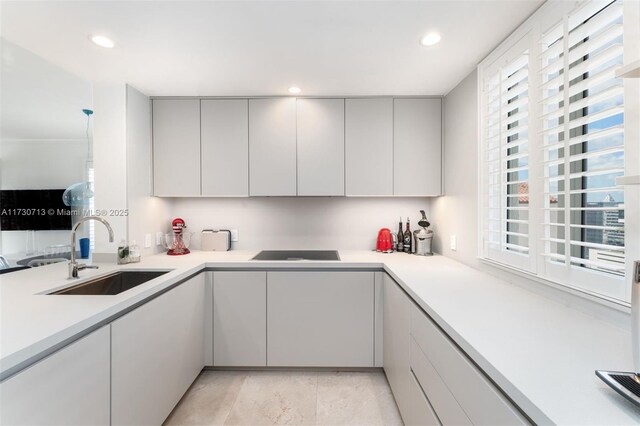 kitchen with plenty of natural light, sink, and black electric stovetop