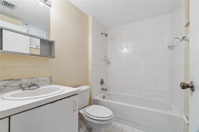 full bathroom with tiled shower / bath, vanity, toilet, and tile patterned flooring