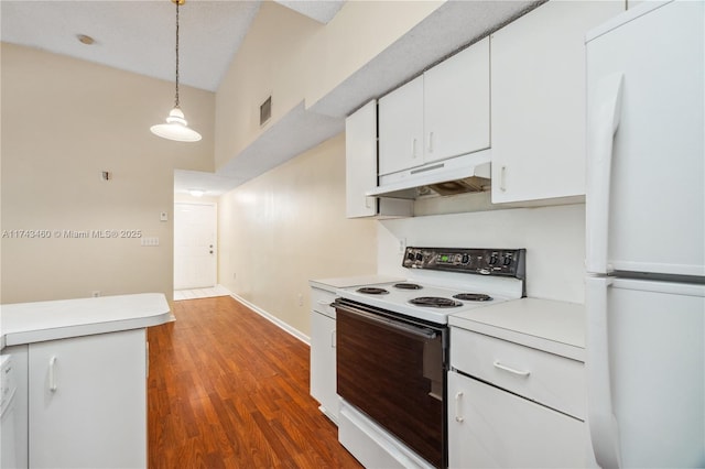 kitchen with range with electric stovetop, white fridge, pendant lighting, and white cabinets