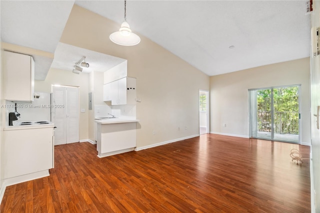 kitchen featuring dark hardwood / wood-style floors, white electric range, decorative light fixtures, sink, and white cabinets