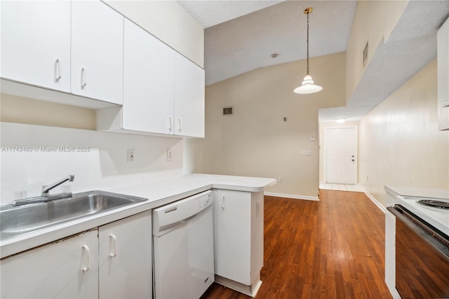 kitchen with white appliances, dark wood-type flooring, white cabinets, decorative light fixtures, and kitchen peninsula