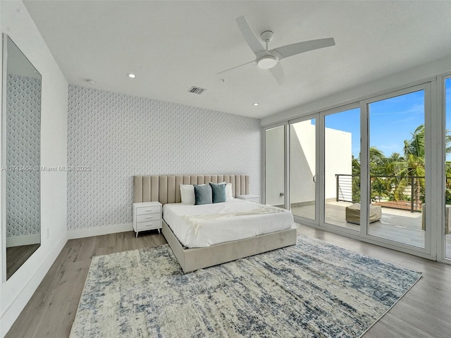 bedroom featuring ceiling fan, access to exterior, and light hardwood / wood-style floors