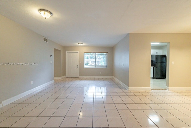 spare room featuring light tile patterned flooring