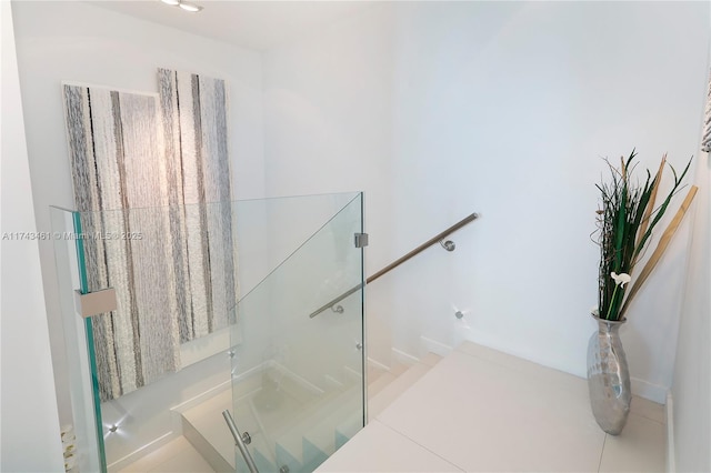 staircase featuring a shower with shower door