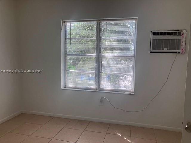 tiled spare room with a wall mounted air conditioner