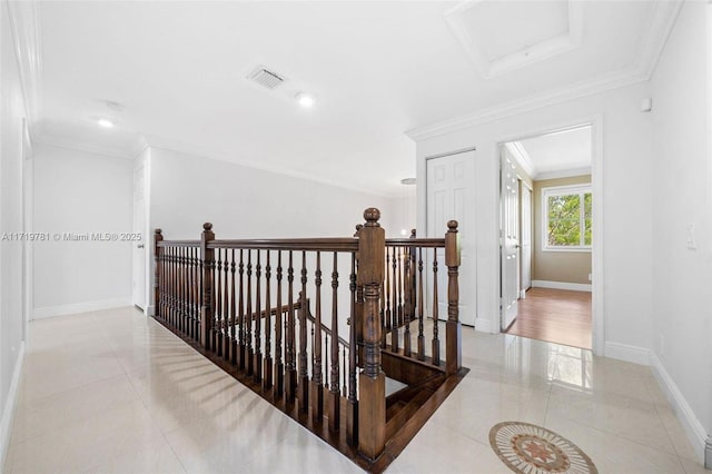 hallway featuring crown molding and light tile patterned floors