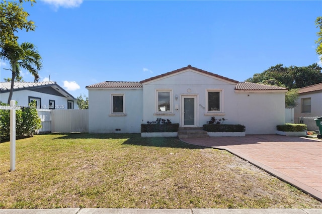 mediterranean / spanish house featuring a front yard