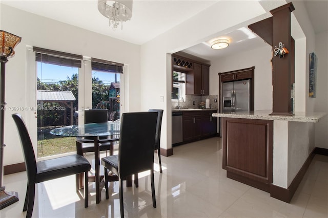 dining room with an inviting chandelier and sink