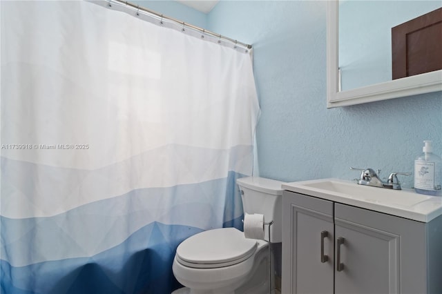 bathroom with vanity, toilet, and a shower with shower curtain