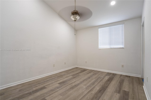 unfurnished room with lofted ceiling, wood-type flooring, and ceiling fan