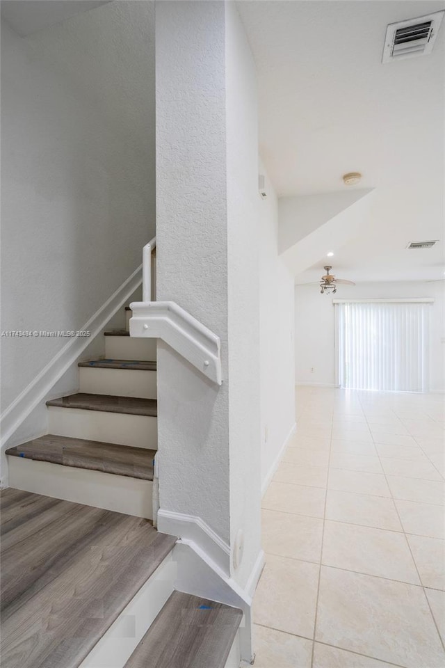 stairway with tile patterned flooring