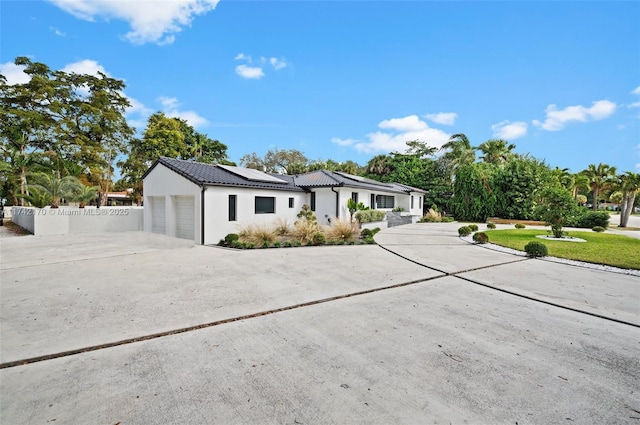 view of front of house featuring a garage and solar panels