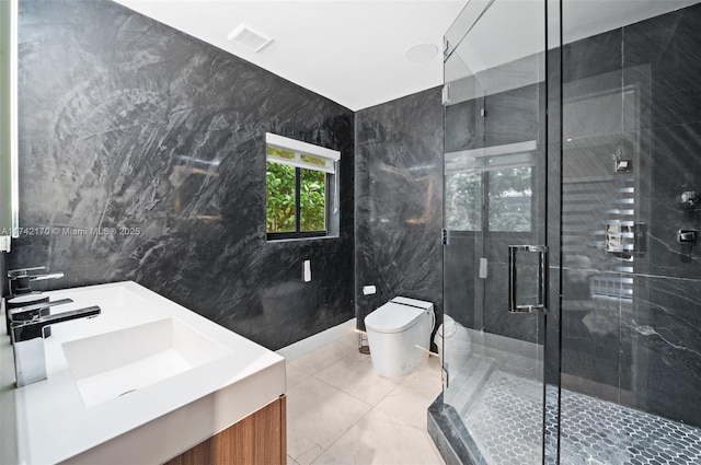 bathroom featuring vanity, toilet, a shower with door, and tile walls