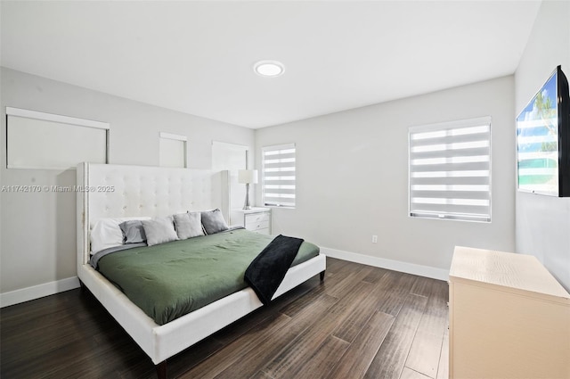 bedroom with dark wood-type flooring