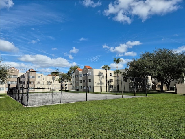 view of basketball court with a lawn