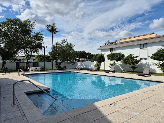 view of swimming pool with a patio