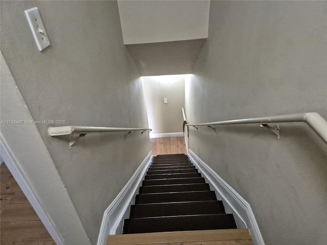 stairs featuring hardwood / wood-style flooring