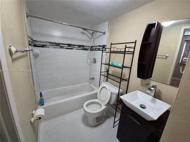 full bathroom with vanity, tiled shower / bath combo, tile patterned floors, and toilet