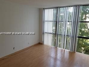 unfurnished room featuring hardwood / wood-style floors