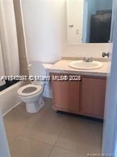 bathroom featuring tile patterned flooring, vanity, and toilet