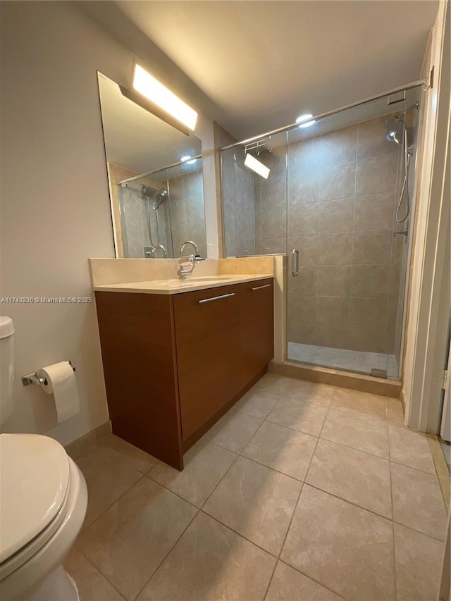 bathroom with walk in shower, vanity, toilet, and tile patterned flooring