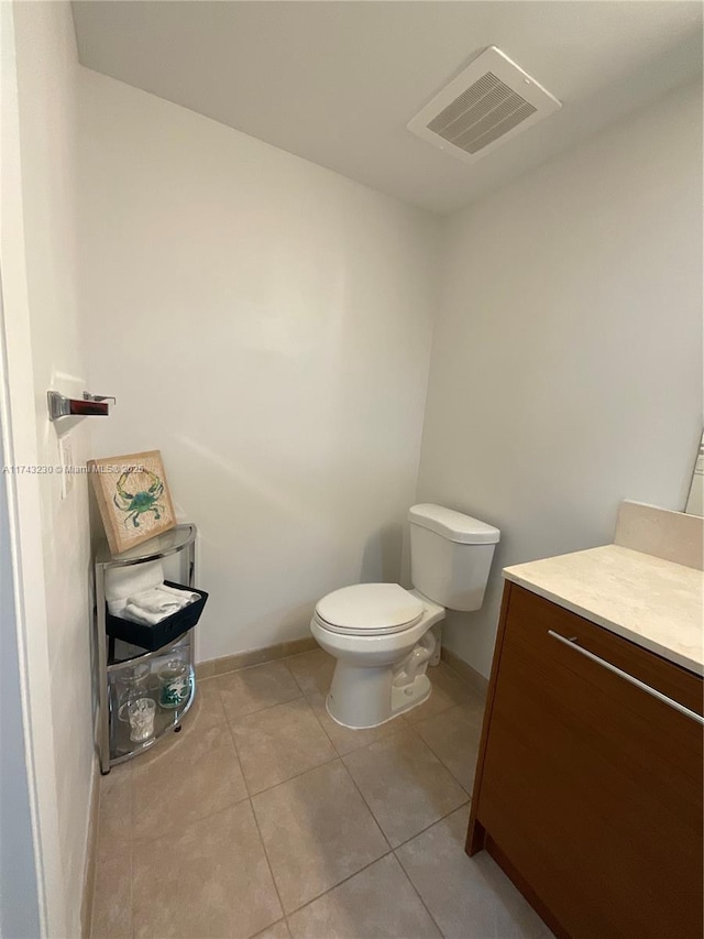 bathroom with tile patterned floors, vanity, and toilet