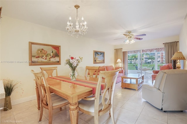 tiled dining space featuring ceiling fan with notable chandelier