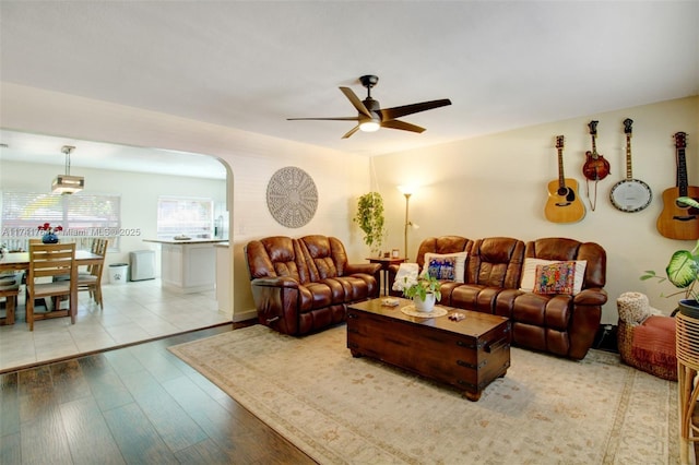 living room featuring ceiling fan and light wood-type flooring