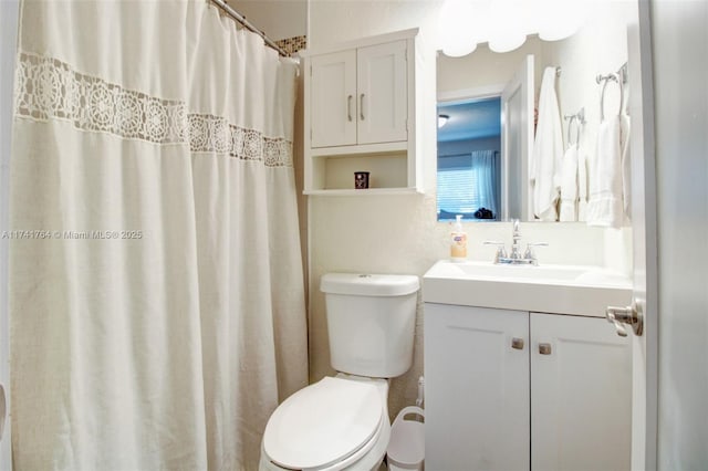 bathroom with vanity, toilet, and a shower with shower curtain