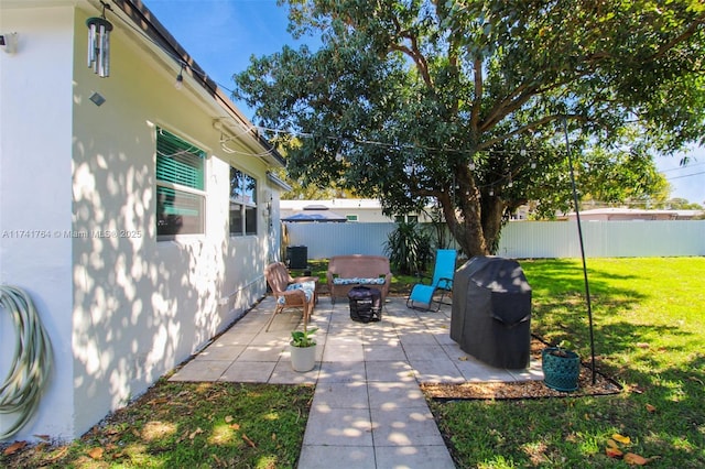 view of patio / terrace with a hot tub and a grill