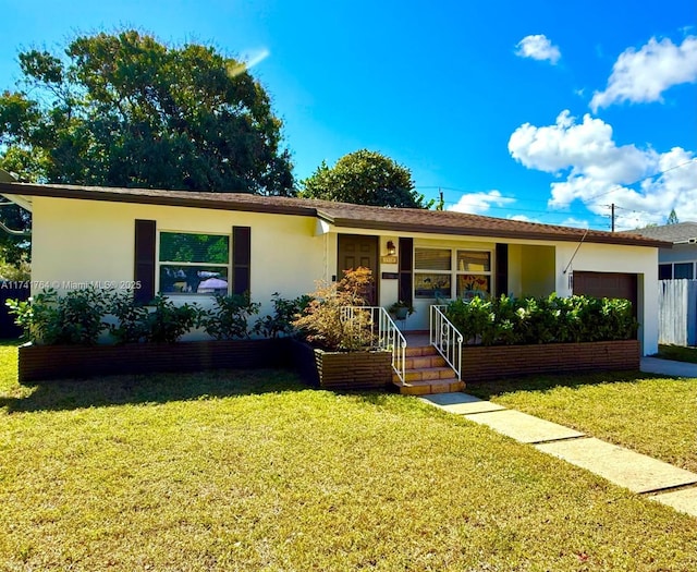 ranch-style home featuring a garage and a front lawn