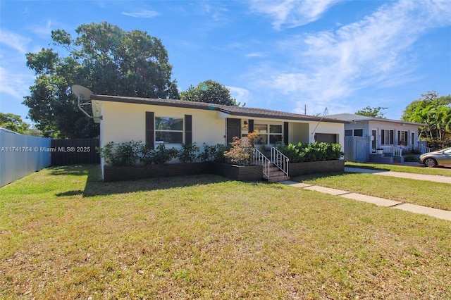 ranch-style house featuring a front yard