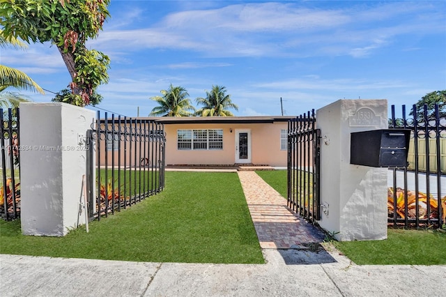 exterior space with a fenced front yard, a front yard, and a gate