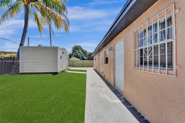 view of yard featuring a fenced backyard and an outdoor structure