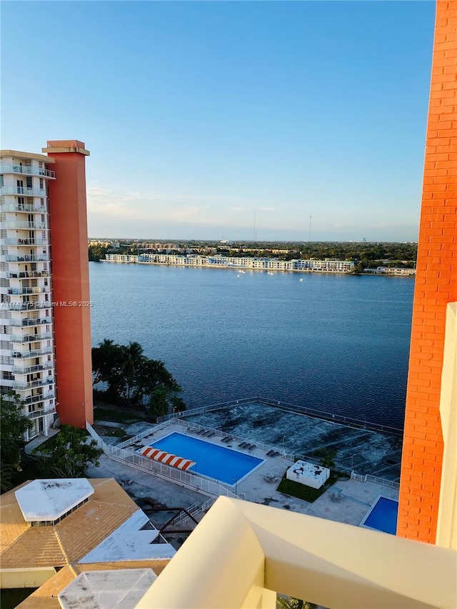 view of swimming pool with a water view