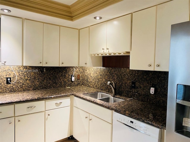 kitchen with refrigerator with ice dispenser, dishwasher, sink, and dark stone countertops