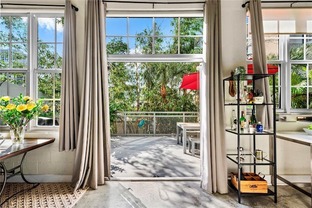 doorway to outside with concrete floors