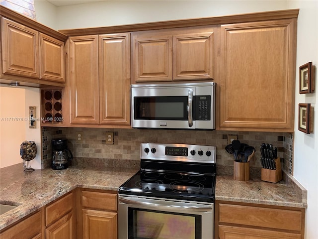 kitchen with backsplash, stainless steel appliances, and stone counters